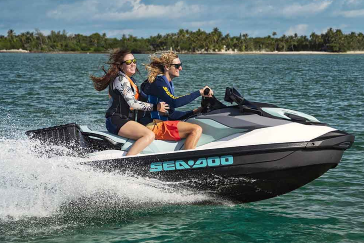 a person riding on the back of a boat in a body of water